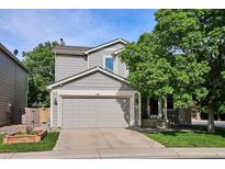 Charming gray two-story home featuring a two-car garage and well-maintained front yard at 1169 S Alton Ct, Denver, CO 80247