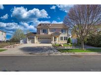 Charming two-story home with a three-car garage, inviting curb appeal, and beautiful landscaping at 21229 E 50Th Ave, Denver, CO 80249