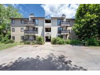 Apartment building exterior with balconies, landscaping, and visible unit number at 6505 Kalua Rd # 104B, Boulder, CO 80301