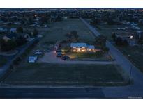 Aerial view of house, expansive lot, and surrounding area at dusk at 12626 N 1St St, Parker, CO 80134