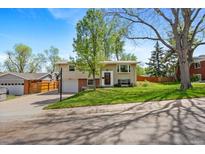 Charming home with a well-maintained lawn and mature trees at 8022 S Jay Dr, Littleton, CO 80128