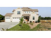 Charming two-story home boasts a well-manicured lawn, three-car garage and a welcoming front porch, perfect for relaxation at 1221 W 144Th Ct, Westminster, CO 80023