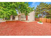 Charming two-story home with light colored siding and well maintained front yard at 4848 S Pitkin Way, Aurora, CO 80015