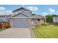 Charming two-story home with a brick and siding exterior and an attached two-car garage at 6017 S Pierson St, Littleton, CO 80127
