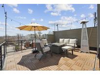 Inviting rooftop deck with stylish furniture, a cozy fire pit, and city views, perfect for outdoor entertaining at 2624 N Clay St, Denver, CO 80211