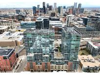 Stunning aerial view showcasing a modern high-rise apartment building with city skyline views at 1700 Bassett St # 314, Denver, CO 80202