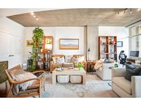 Inviting living room featuring stylish furniture, decor, and abundant natural light at 1700 Bassett St # 314, Denver, CO 80202