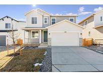 Charming two-story home with a two-car garage, neutral colors, and manicured front yard at 4582 Boone Cir, Brighton, CO 80601