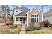 Charming two-story home with brick accents, mature landscaping, and welcoming front porch at 1011 S Valentia St # 118, Denver, CO 80247