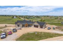 New construction home with a modern design and attached two-car garage on a spacious lot at 1286 Lisbon Dr, Parker, CO 80138