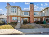 Charming two-story townhome featuring brick facade, neutral trim, and well-maintained landscaping at 3006 W 107Th Pl # D, Westminster, CO 80031