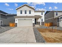 Charming two-story home with a two-car garage, and a well-maintained front yard at 4464 Boone Cir, Brighton, CO 80601