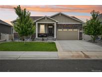 Charming single-Gathering home with stone accents, a covered porch, and a two-car garage at 8919 Ferncrest St, Longmont, CO 80504
