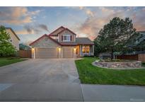 Charming two-story home featuring a stone facade, three-car garage, and landscaped front yard at 5048 Rocky Mountain Dr, Castle Rock, CO 80109