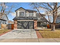 Two-story brick home with a large front yard and driveway at 447 Woodson Dr, Erie, CO 80516