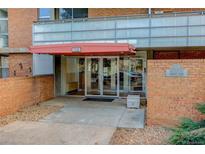Modern building entrance with double doors and brick facade at 2500 S York St # 107, Denver, CO 80210
