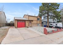 Charming two-story home featuring a red garage door, neutral siding, and mature landscaping for great curb appeal at 3977 S Pitkin Way, Aurora, CO 80013