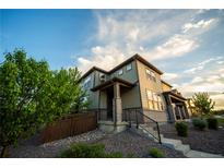 Inviting two-story home with modern architectural details, stone accents, and a well-maintained landscaped front yard at 359 Courtfield Way, Castle Pines, CO 80108