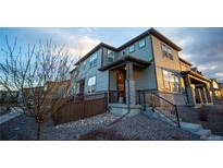 Inviting two-story home featuring professional rock landscaping, a cozy front porch, and neutral siding at 359 Courtfield Way, Castle Pines, CO 80108