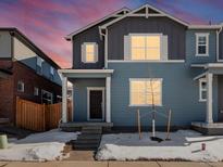 Two-story home with gray siding and a charming front porch at 229 Mayfly Ln, Berthoud, CO 80513