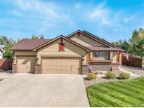 Charming single-Gathering home featuring a three-car garage, lush lawn, and inviting curb appeal at 21863 E Oxford Pl, Aurora, CO 80018