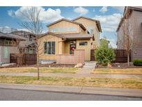Inviting two-story home featuring a neutral color palette and a well-maintained front yard landscape at 9734 Bennett Peak St, Littleton, CO 80125