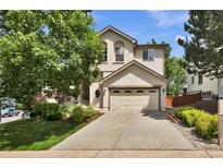 Two-story home featuring a two-car garage and well-maintained front yard at 4678 Springmeadow Ln, Castle Rock, CO 80109