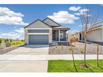 Charming single-Gathering home showcasing a two-car garage and xeriscaped front yard at 9265 Cathay Ct, Commerce City, CO 80022