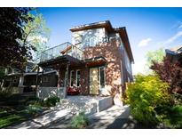 Modern two-story home boasting a brick facade and spacious balcony for outdoor enjoyment at 814 S High St, Denver, CO 80209