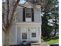 Charming townhome with white trim, black shutters, and well-maintained front lawn at 10515 W Dartmouth Ave, Lakewood, CO 80227