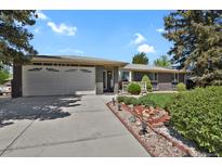 Charming single-Gathering home with a two-car garage, a well-manicured lawn and attractive landscaping at 2301 Dunbar Ct, Longmont, CO 80501