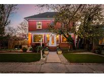 Charming red brick home featuring an inviting walkway and manicured front yard at sunset at 1521 Pontiac St, Denver, CO 80220