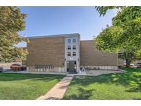 Brick building exterior with landscaping and parking at 1612 Cottonwood Dr # 2W, Louisville, CO 80027