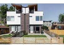 Modern two-story home with a well-manicured lawn, rooftop decks, and a charming fenced-in yard at 1457 Yates St, Denver, CO 80204