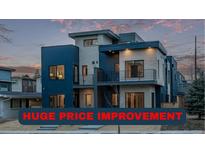 Modern two-story home featuring a balcony, large windows, and unique architectural design at 535 Josephine St, Denver, CO 80206