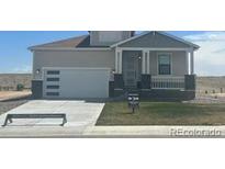 Charming single-Gathering home with a modern garage door and covered front porch at 42976 Colonial Trl, Elizabeth, CO 80107