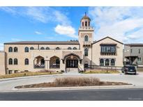 Stunning condo exterior featuring a unique tower, beautiful architecture and well-maintained landscaping at 4625 W 50Th Ave # 110, Denver, CO 80212