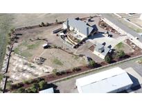 Expansive aerial view of a property featuring a large home, fenced yard, and outbuildings on a spacious lot at 15280 Bannock St, Broomfield, CO 80023