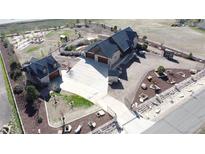 Expansive aerial view of the custom home with a long driveway, guest house, large yard, and beautiful landscaping at 15280 Bannock St, Broomfield, CO 80023