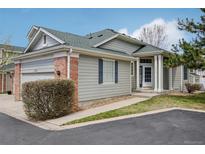Charming home featuring a gray siding exterior, well-manicured lawn, and inviting entrance at 12879 E Dickensen Pl, Aurora, CO 80014