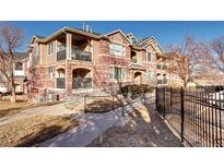 A charming brick condo complex featuring private balconies and convenient ramp access at 8940 Fox Dr # 5-204, Thornton, CO 80260