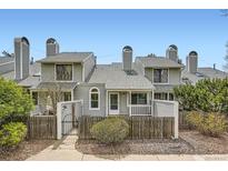 Charming townhome featuring a fenced front yard and unique architectural details at 494 Owl Dr # 4, Louisville, CO 80027