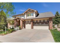 Charming two-story home featuring a three car garage, landscaped yard, and brick and siding accents at 7132 S Tempe Ct, Aurora, CO 80016