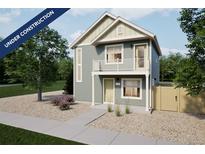 Charming two-story home featuring a quaint balcony and a welcoming, landscaped front yard at 46561 Avery Ln, Bennett, CO 80102