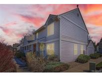 Charming multi-level home featuring tidy landscaping, a columned front porch, and muted siding at 7912 S Depew St # A, Littleton, CO 80128
