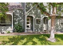 Charming exterior of home featuring inviting entrance, green siding, and well-maintained landscaping at 2059 S Balsam St, Lakewood, CO 80227