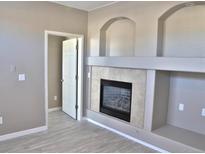 Living room with fireplace and built-in shelving at 1520 S Florence Way # 108, Aurora, CO 80247