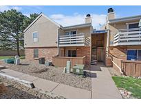 Charming townhome exterior with a cozy balcony and well-maintained landscaping at 3332 S Ammons St # 103, Lakewood, CO 80227