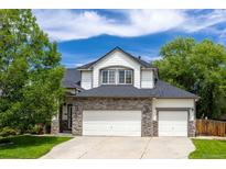 Charming two-story home with stone accents and a well-maintained front lawn at 3775 Balderas St, Brighton, CO 80601