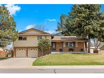 Charming two-story home with a well-manicured lawn, brick accents, and a two-car garage, perfect for Gathering living at 2160 S Flower St, Lakewood, CO 80227